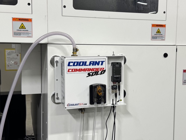Coolant Commander SOLO magnet-mounted to the side of a CNC machining center with clean hose routing